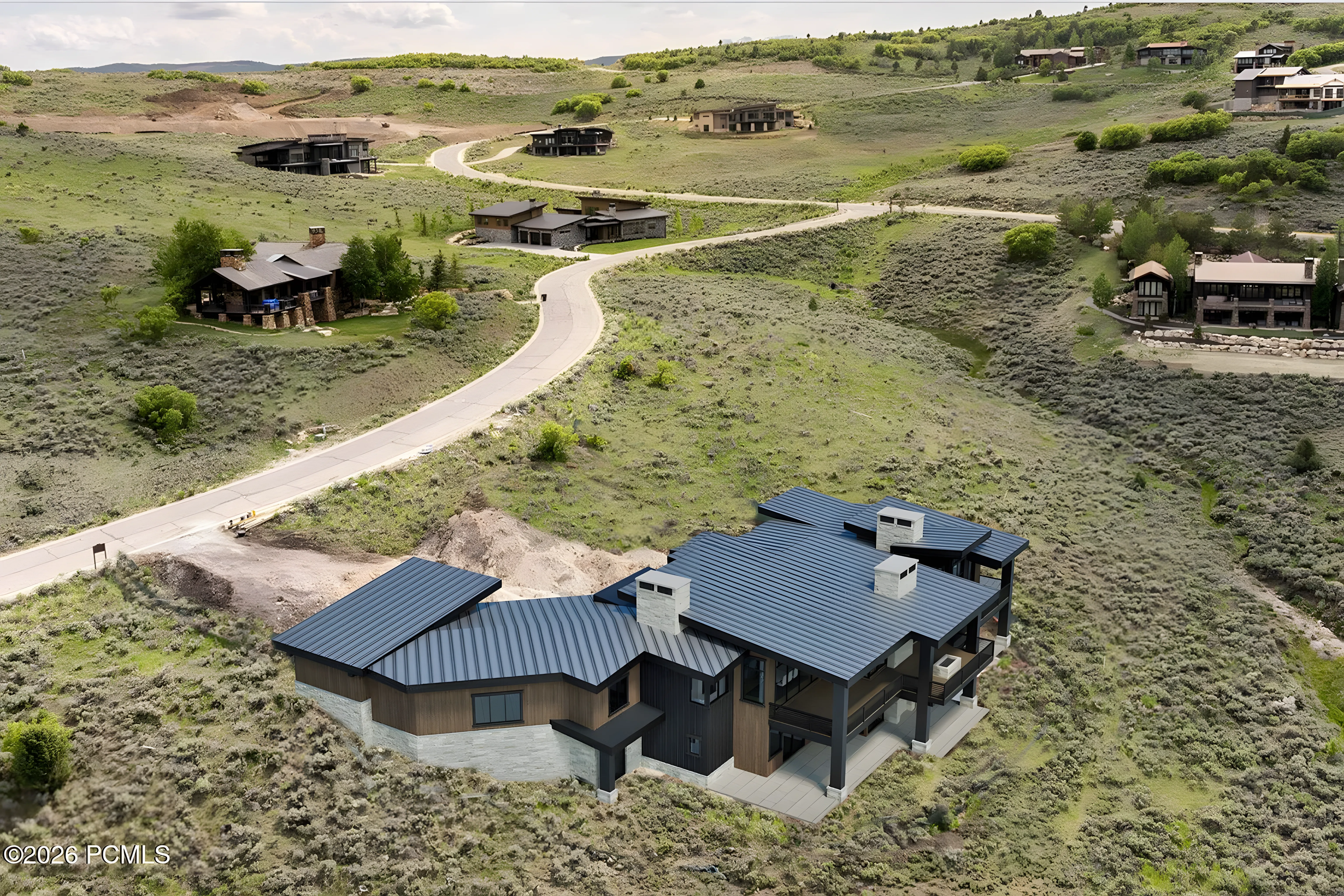Tuhaye Golf Retreat aerial overview with golf course and Uinta Mountains behind